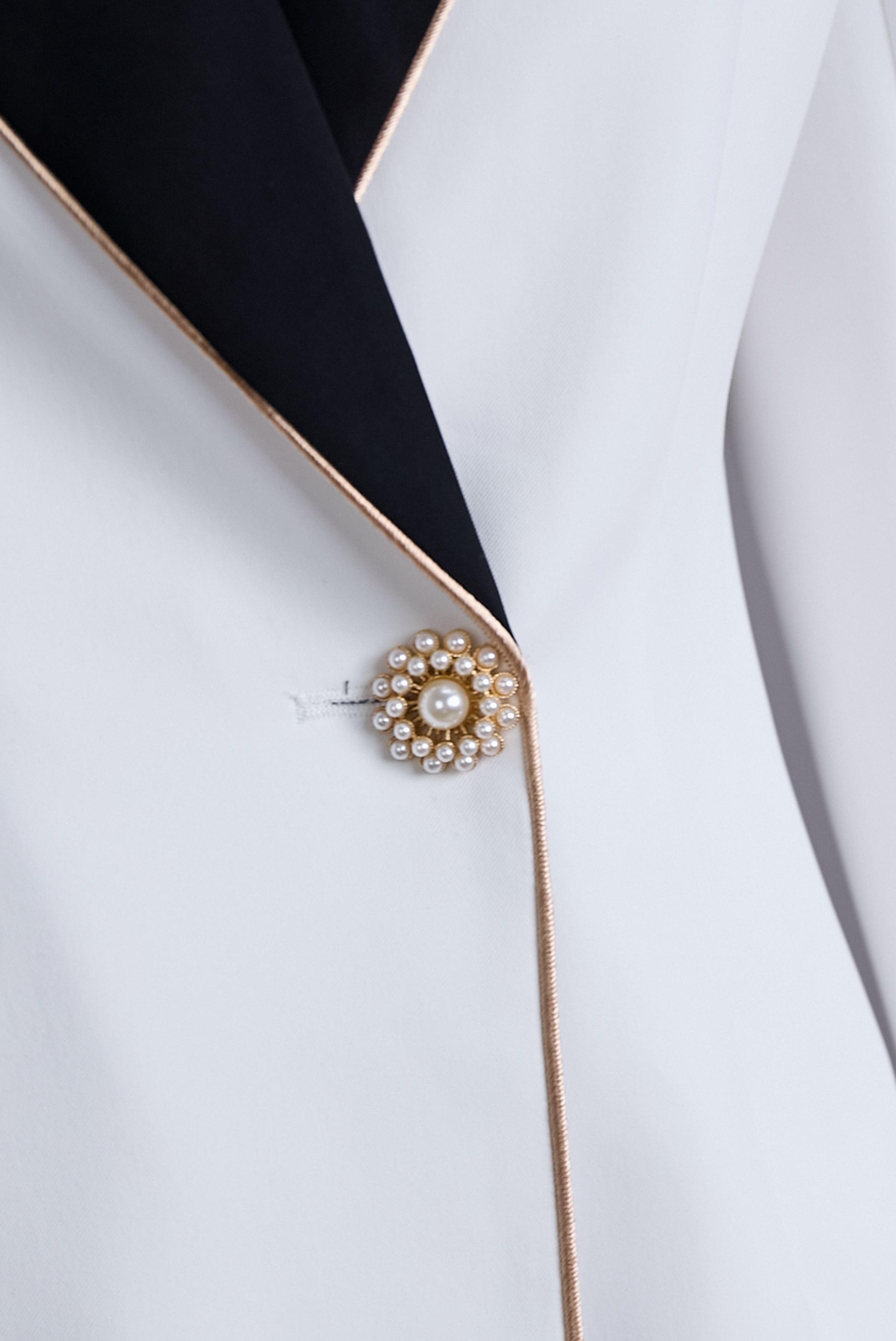 Moya Asymmetrical Blazer | Elegant White with Black Lapels, Gold Button Detail 5